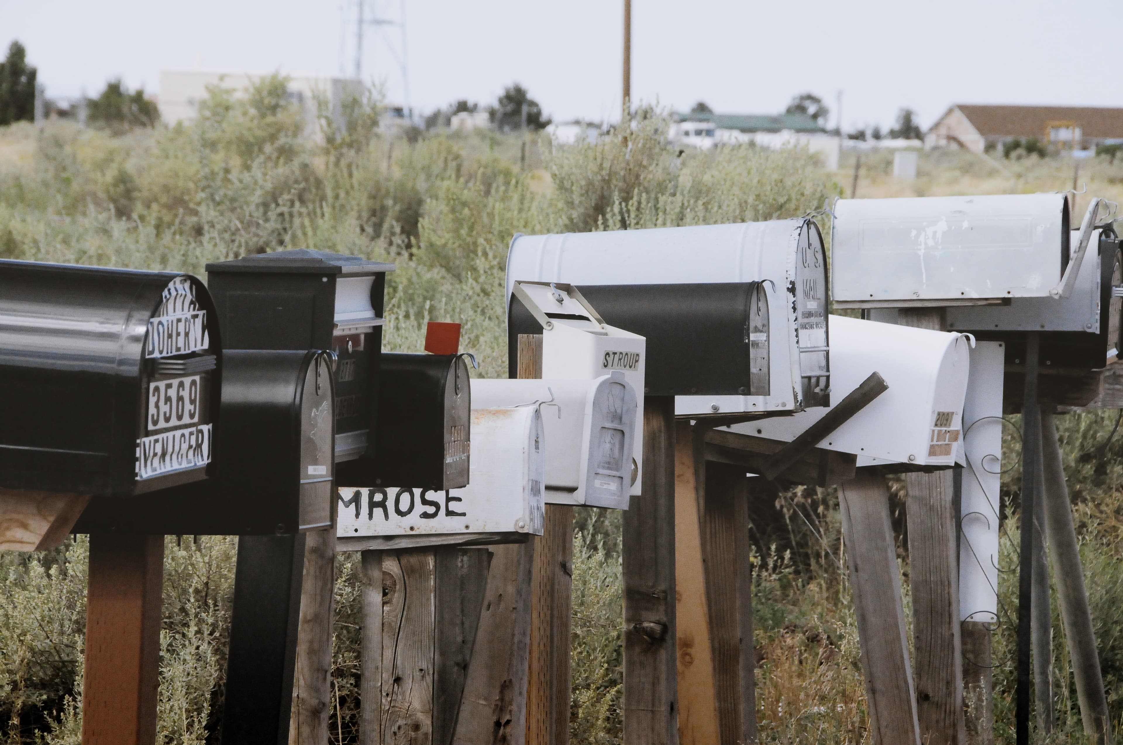 Some letterboxes in a row on a typical american street.